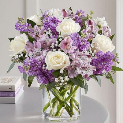 Lovely memories are made with thoughtful gifts for the ones we care about. Our charming bouquet is loosely gathered with a medley of lavender & white blooms. Hand-designed inside a clear cylinder vase with cascading greenery all around, it’s a wonderful way to express the sentiments you have inside your heart.